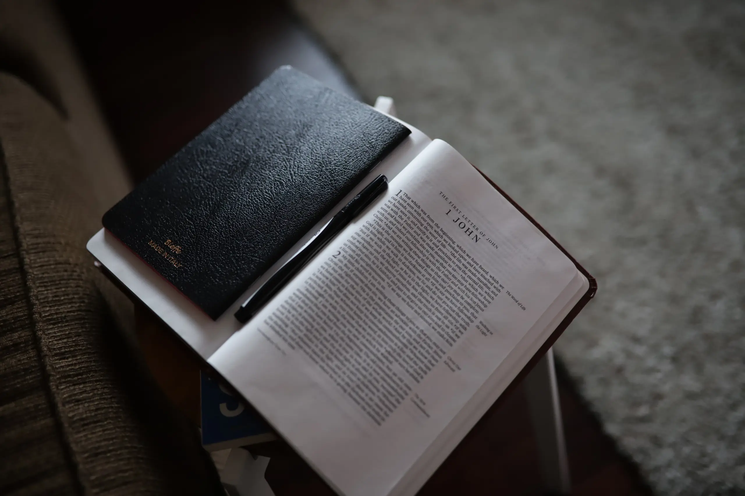 Open Bible with notepad and pen